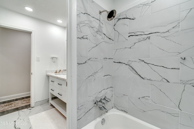 bathroom with vanity and tiled shower / bath combo