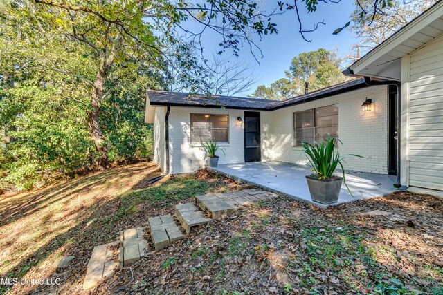 rear view of property featuring a patio area