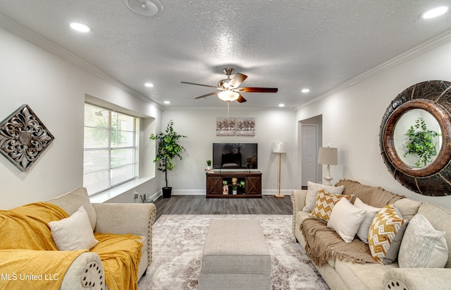 living room featuring wood-type flooring, a textured ceiling, ceiling fan, and crown molding