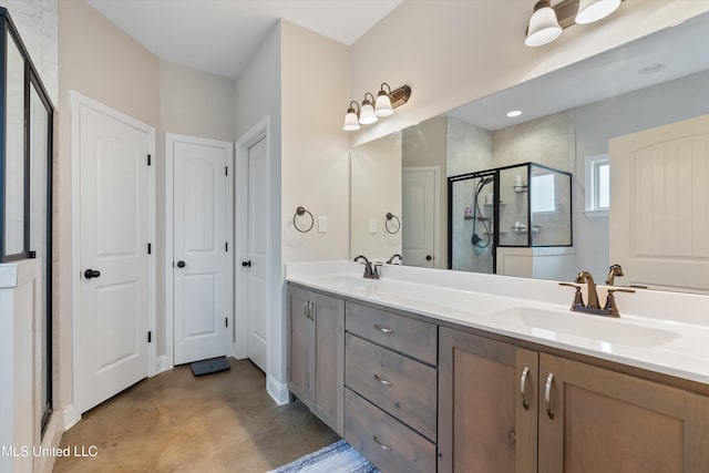 full bath with double vanity, a shower stall, finished concrete flooring, and a sink