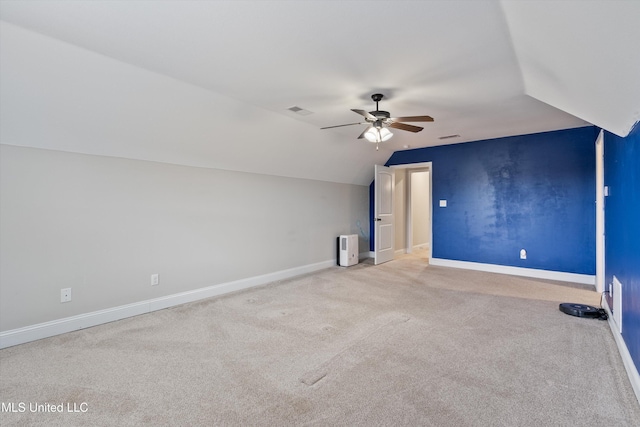 additional living space featuring lofted ceiling, light colored carpet, and ceiling fan