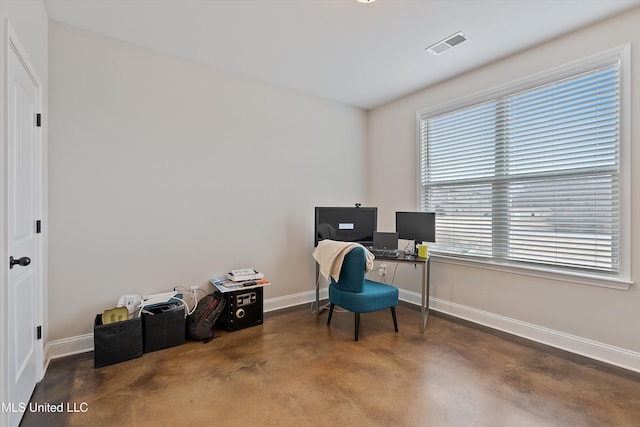 office area featuring baseboards, finished concrete floors, and visible vents