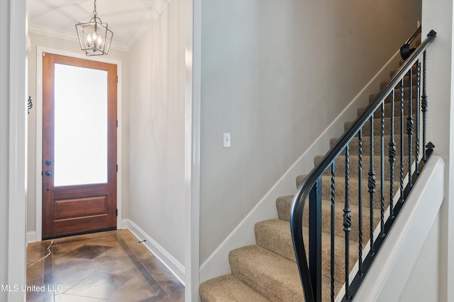 foyer entrance featuring ornamental molding and baseboards