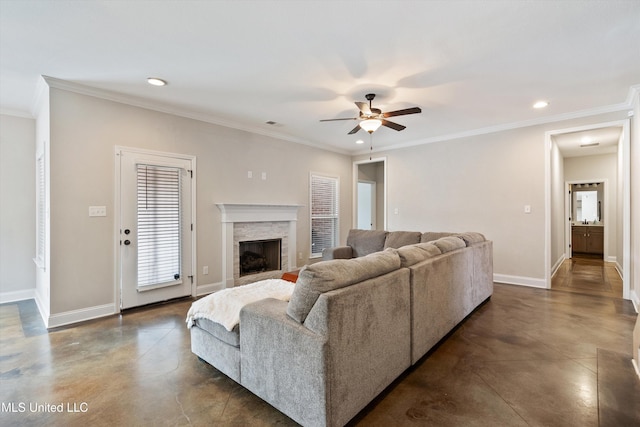 living room featuring crown molding, a stone fireplace, and ceiling fan