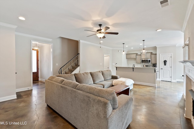 living area featuring concrete flooring, a fireplace, visible vents, and baseboards