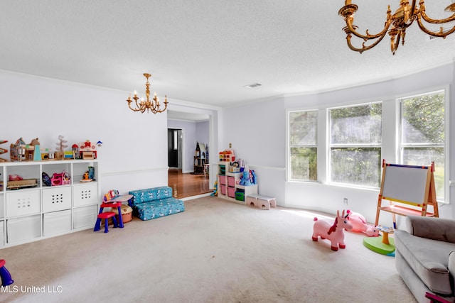 9618 Paige Bayou Rd, Vancleave, MS 39565 - playroom with a chandelier, carpet floors, a textured ceiling, and ornamental molding