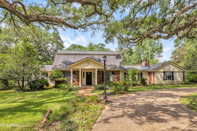 9618 Paige Bayou Rd, Vancleave, MS 39565 - view of front facade with a front yard, a chimney, curved driveway, and roof with shingles