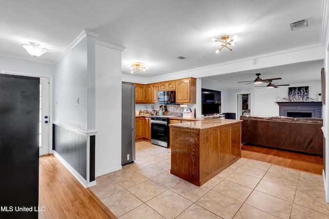 9618 Paige Bayou Rd, Vancleave, MS 39565 - kitchen featuring stainless steel appliances, a peninsula, ornamental molding, a ceiling fan, and open floor plan