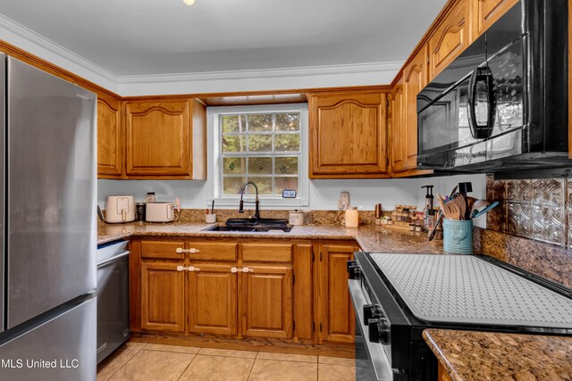 9618 Paige Bayou Rd, Vancleave, MS 39565 - kitchen featuring stainless steel appliances, a sink, brown cabinets, and light tile patterned floors