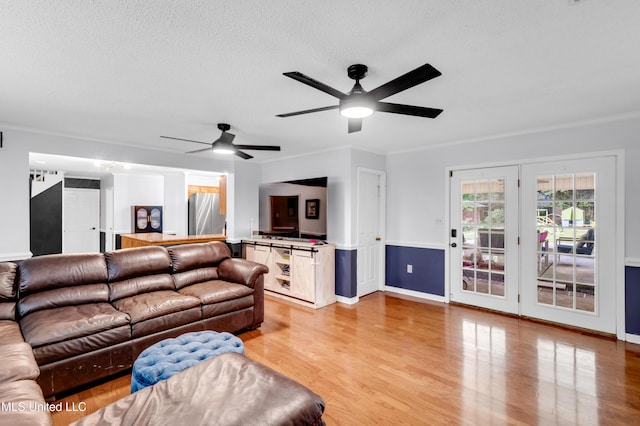 9618 Paige Bayou Rd, Vancleave, MS 39565 - living room with light wood-style flooring, a ceiling fan, a textured ceiling, ornamental molding, and baseboards