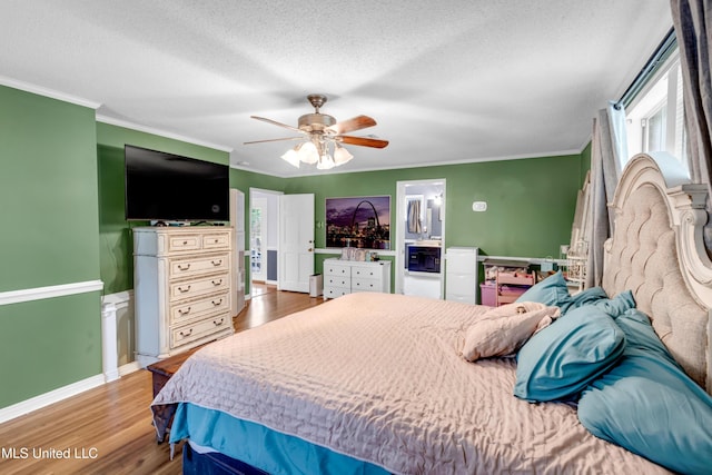 9618 Paige Bayou Rd, Vancleave, MS 39565 - bedroom featuring ornamental molding, wood finished floors, a textured ceiling, ceiling fan, and baseboards