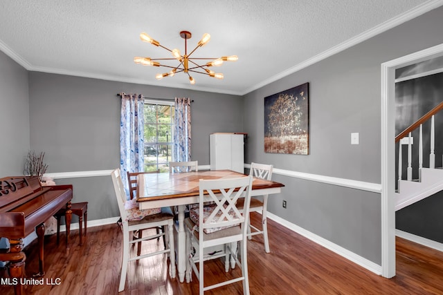 9618 Paige Bayou Rd, Vancleave, MS 39565 - dining area with a chandelier, a textured ceiling, wood finished floors, baseboards, and crown molding