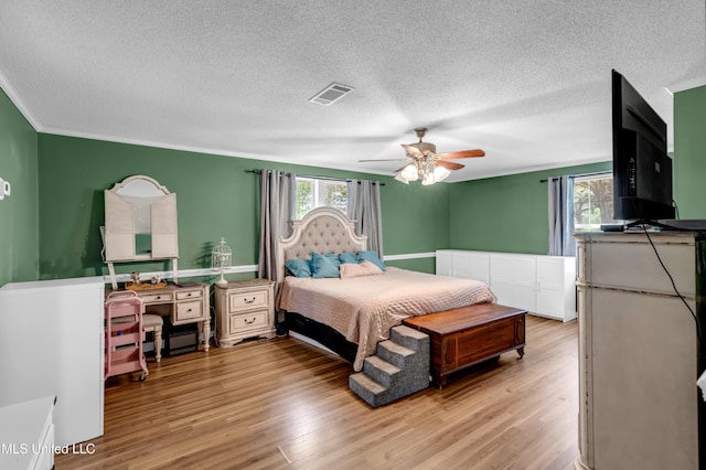 9618 Paige Bayou Rd, Vancleave, MS 39565 - bedroom featuring multiple windows, a textured ceiling, wood finished floors, ceiling fan, and ornamental molding