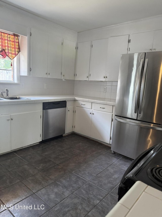 104 Mcgregor Way, Natchez, MS 39120 - kitchen featuring white cabinets, stainless steel appliances, tile counters, and decorative backsplash