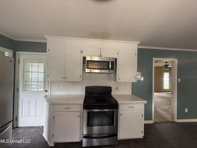 104 Mcgregor Way, Natchez, MS 39120 - kitchen featuring stainless steel appliances, tile countertops, and a wealth of natural light
