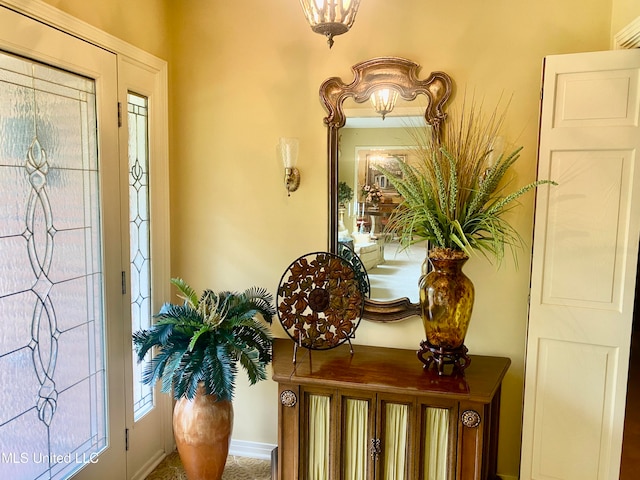 view of carpeted foyer entrance