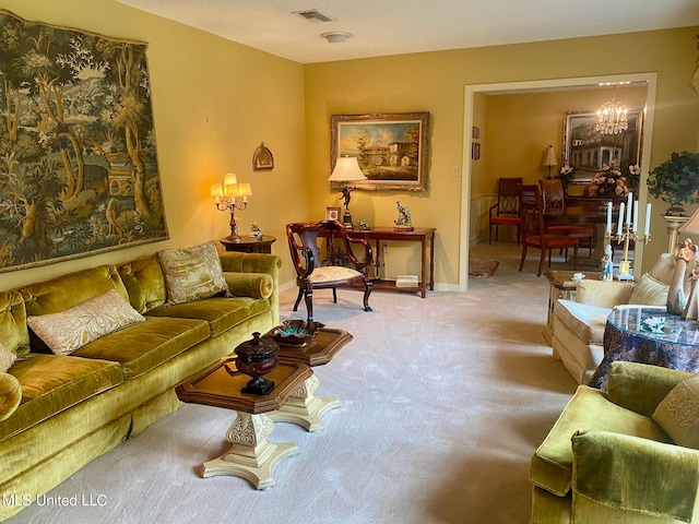 living room with light carpet and an inviting chandelier