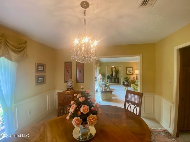 dining area featuring a notable chandelier