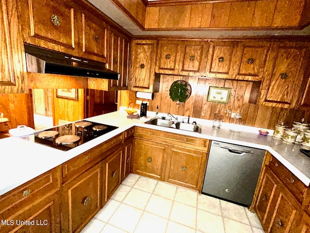 kitchen with sink, light tile patterned flooring, dishwasher, black electric cooktop, and wooden walls