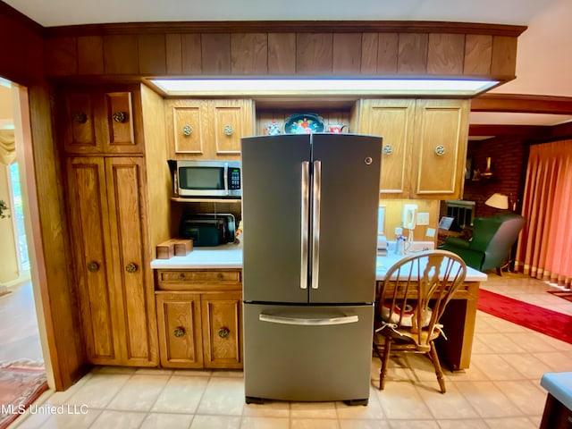 kitchen featuring appliances with stainless steel finishes and light tile patterned floors