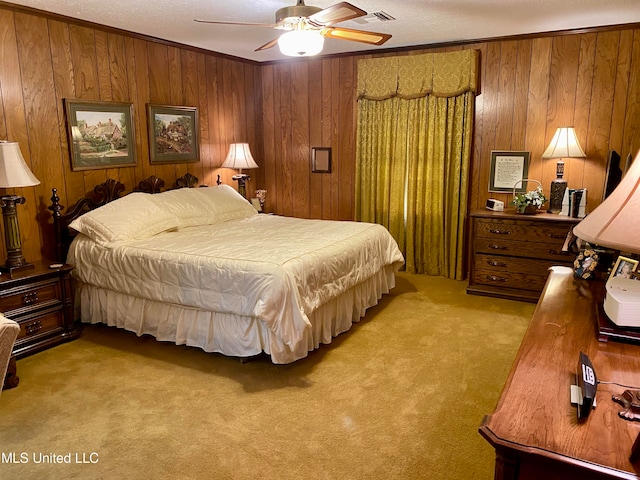 bedroom featuring light carpet, crown molding, wood walls, and ceiling fan