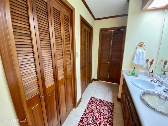 bathroom featuring vanity, tile patterned floors, and ornamental molding