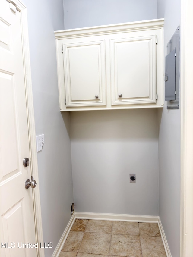 washroom featuring hookup for an electric dryer, electric panel, and cabinets