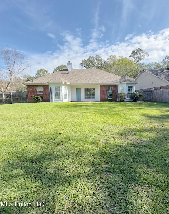 back of house with a yard