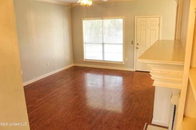 unfurnished room with dark hardwood / wood-style floors, ceiling fan, and crown molding