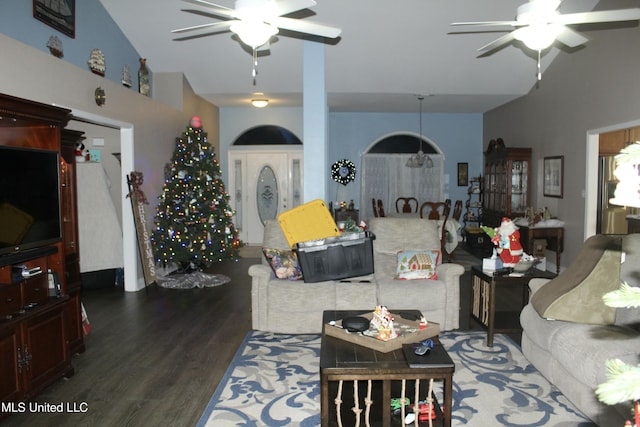 living room featuring ceiling fan, dark hardwood / wood-style flooring, and vaulted ceiling