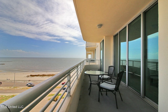 balcony with a water view and a beach view