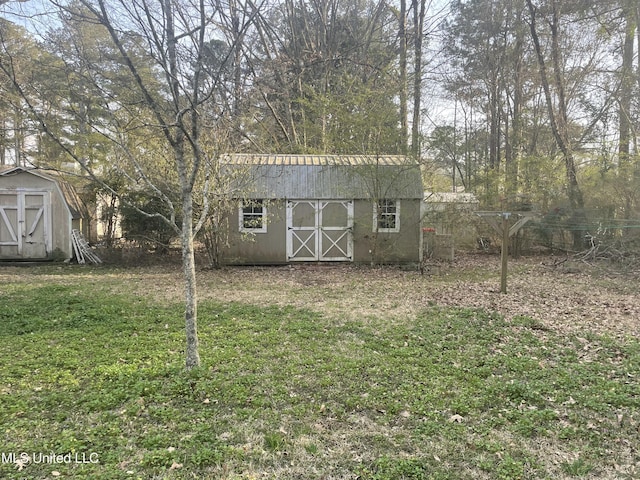 view of yard with an outbuilding and a shed