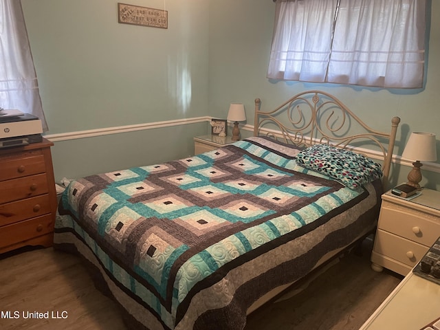 bedroom with wood finished floors