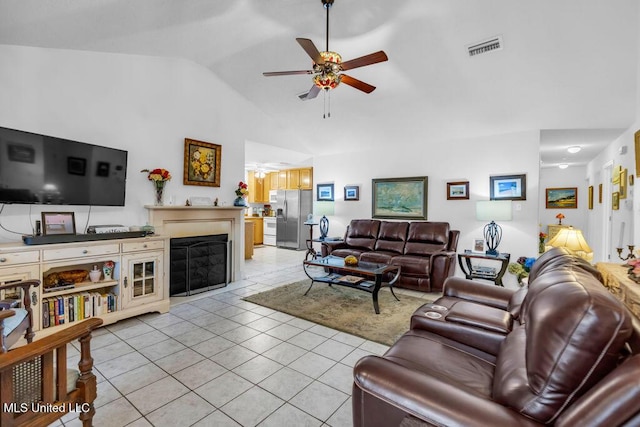 99102 Koloa St, Diamondhead, MS 39525 - living room with a ceiling fan, vaulted ceiling, light tile patterned floors, and a fireplace