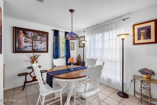 99102 Koloa St, Diamondhead, MS 39525 - dining space featuring plenty of natural light, a textured ceiling, and light tile patterned flooring
