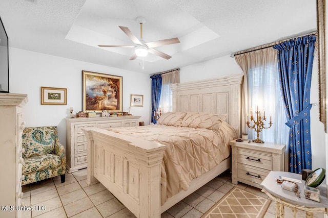 99102 Koloa St, Diamondhead, MS 39525 - bedroom with a tray ceiling, light tile patterned floors, and a ceiling fan