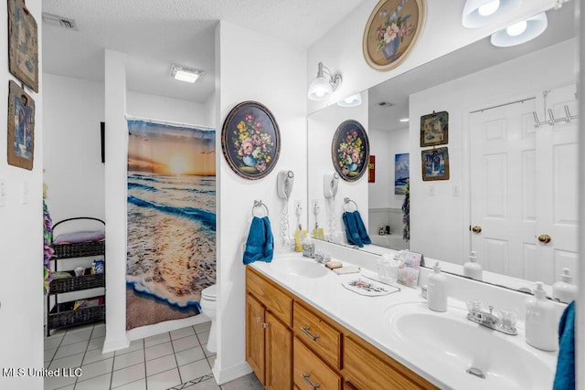 99102 Koloa St, Diamondhead, MS 39525 - bathroom with double vanity, tile patterned floors, and a textured ceiling