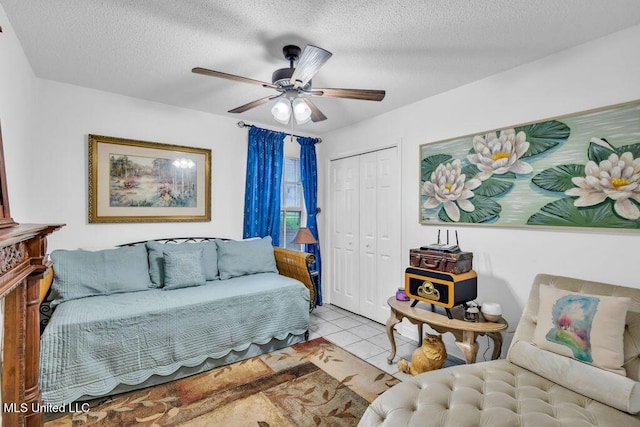 99102 Koloa St, Diamondhead, MS 39525 - tiled living room featuring a ceiling fan and a textured ceiling