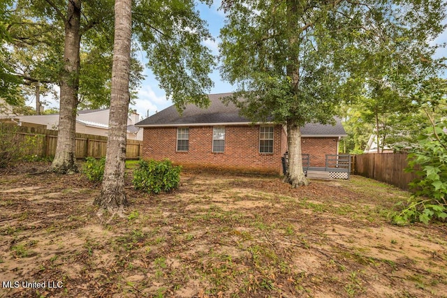 99102 Koloa St, Diamondhead, MS 39525 - rear view of property with brick siding, a fenced backyard, roof with shingles, and a wooden deck