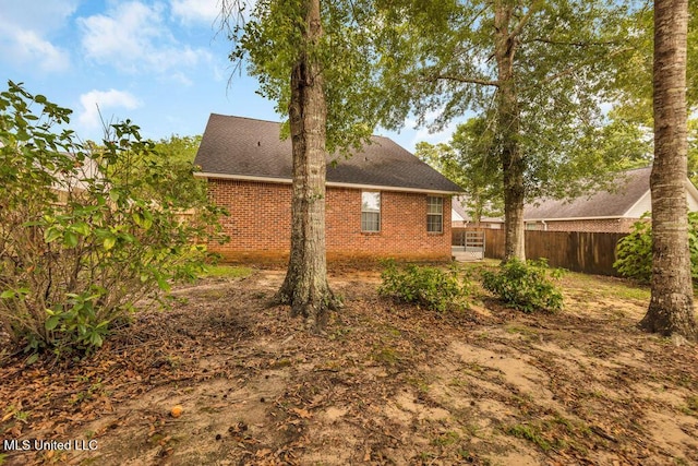 99102 Koloa St, Diamondhead, MS 39525 - view of side of home featuring brick siding and a shingled roof
