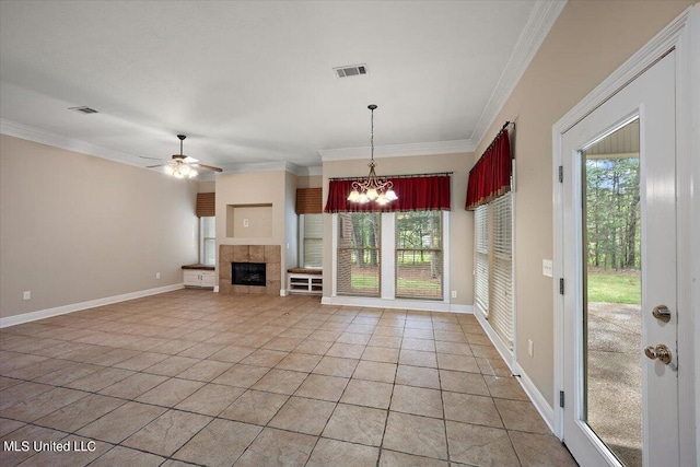 unfurnished living room featuring crown molding, a healthy amount of sunlight, tile patterned floors, and ceiling fan with notable chandelier