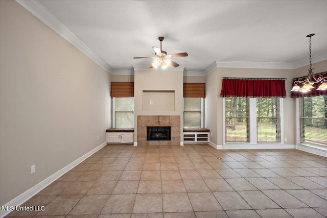 unfurnished living room featuring light tile patterned floors, ornamental molding, a ceiling fan, and a tile fireplace
