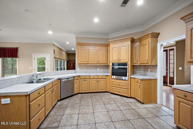 kitchen featuring sink, crown molding, stainless steel appliances, and tasteful backsplash