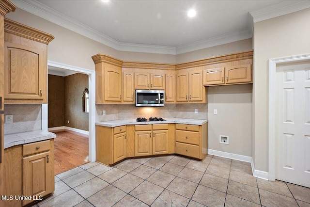 kitchen featuring black gas stovetop, crown molding, decorative backsplash, and light brown cabinets