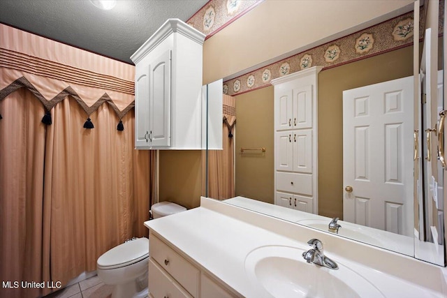 bathroom with vanity, a textured ceiling, tile patterned floors, and toilet