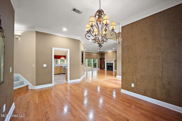 unfurnished dining area featuring light hardwood / wood-style floors and crown molding