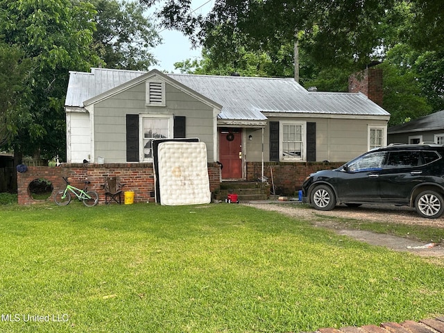 624 S Leflore Ave, Cleveland, MS 38732 - view of front facade featuring a front lawn, metal roof, and brick siding
