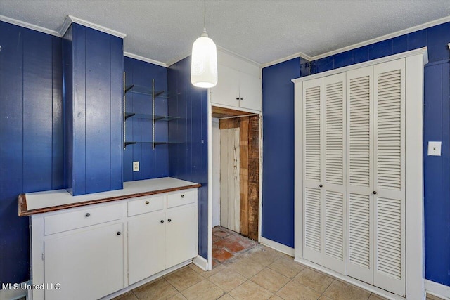 223 Hannah Dr, Clinton, MS 39056 - kitchen featuring ornamental molding, a textured ceiling, white cabinets, pendant lighting, and light countertops