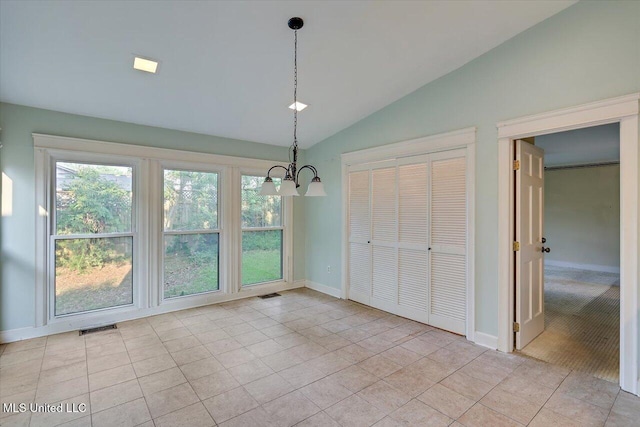 223 Hannah Dr, Clinton, MS 39056 - unfurnished dining area with vaulted ceiling, a chandelier, light tile patterned floors, and baseboards