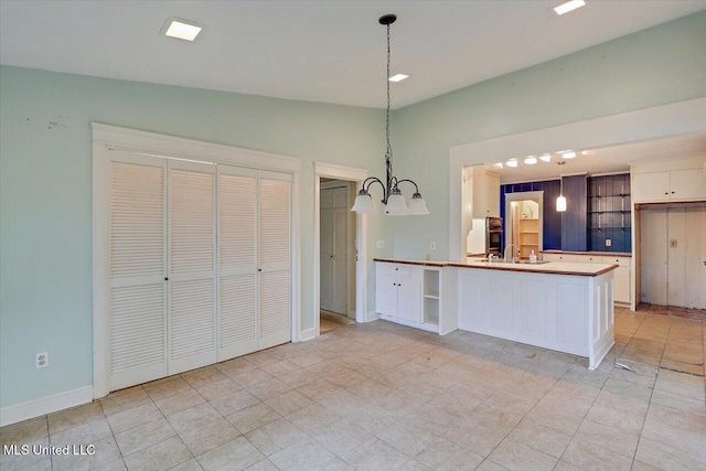 223 Hannah Dr, Clinton, MS 39056 - kitchen with white cabinetry, pendant lighting, a chandelier, open shelves, and baseboards